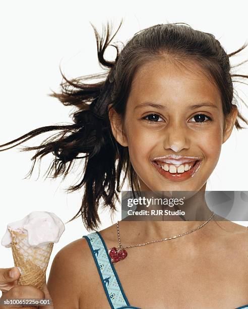 girl (4-5) holding ice-cream cone, smiling, portrait, close-up - girl eating messy ice cream cone stock pictures, royalty-free photos & images