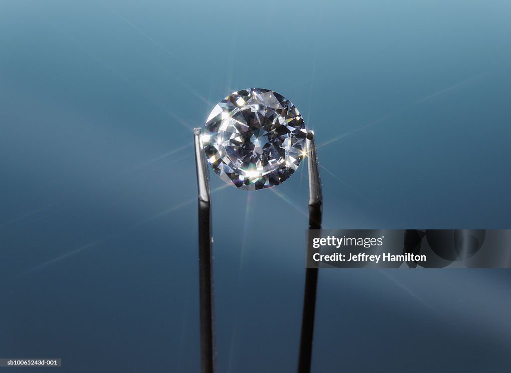Tweezers holding diamond, close-up