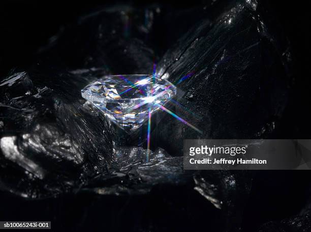 diamond in bed of coal - diamonds stock pictures, royalty-free photos & images
