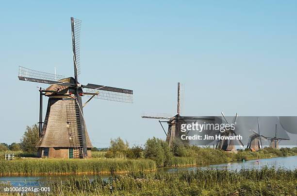 windmills of kinderdijk, built in 1740 to drain the low catch-water basin located between the path and the mills,holland - wt1 stock pictures, royalty-free photos & images