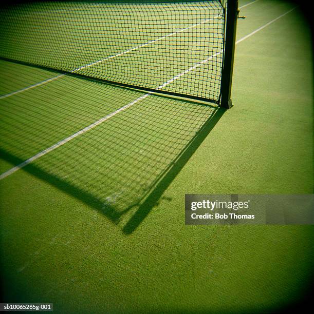 shadow on tennis net in court - tennis net stock pictures, royalty-free photos & images