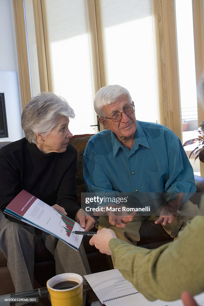 Man and women discussing graph around table