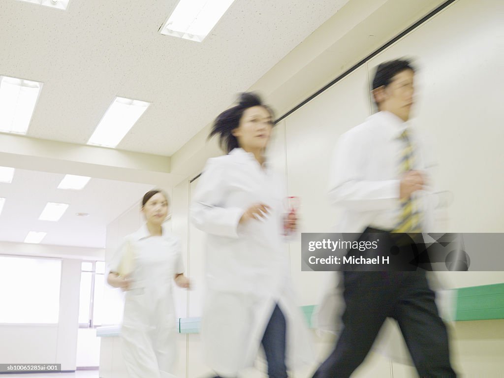 Doctors and nurse running in hospital corridor