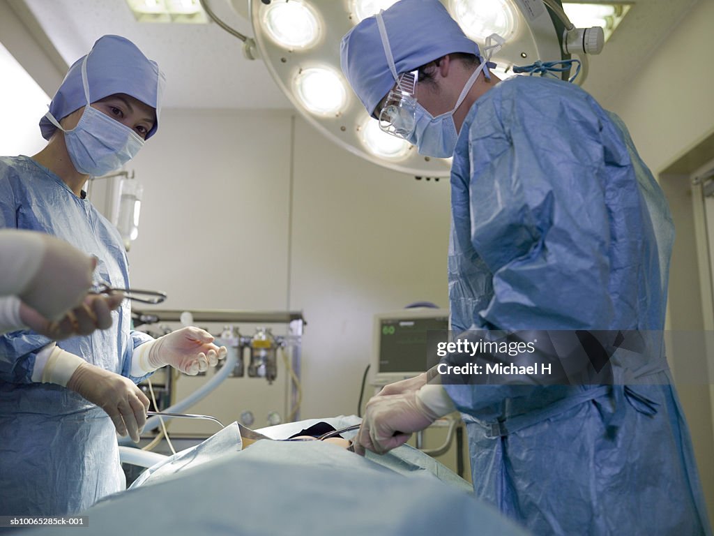 Three surgeons working in operating room
