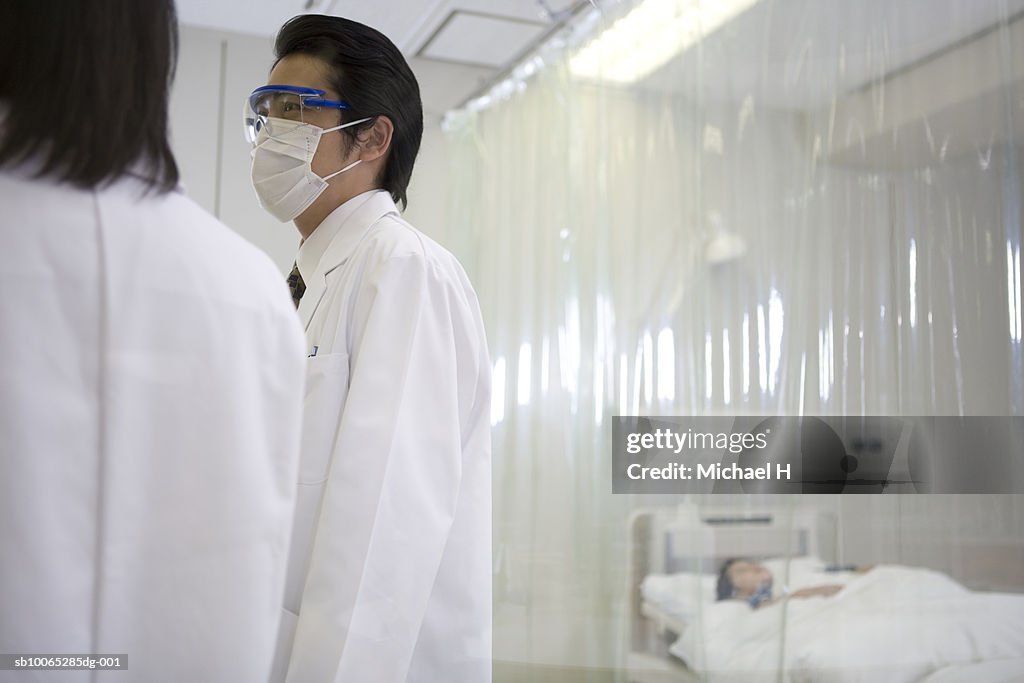 Doctors talking in patient's room