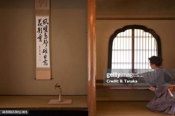 woman in kimono adjusting window in tea room - washitsu stock pictures, royalty-free photos & images