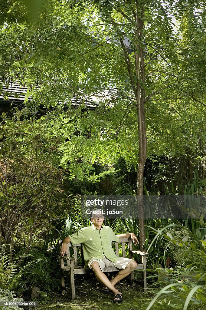 Senior man sitting on garden bench