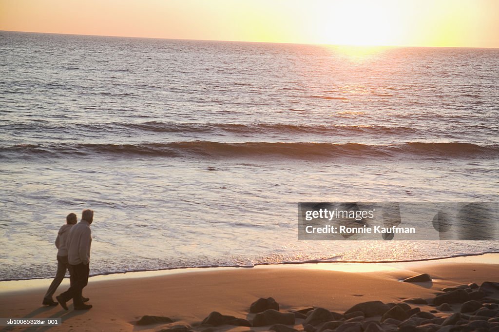 Senior couple walking on beach