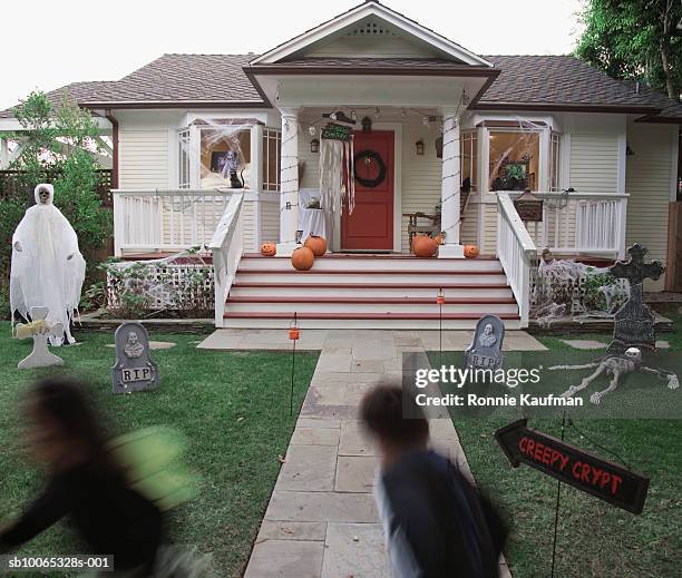 children (4-5) in halloween costume running at house - naughty halloween stock pictures, royalty-free photos & images