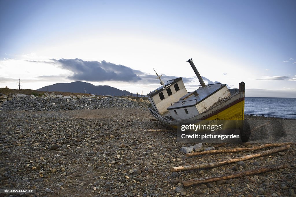 Abandoned shipping boat at waterfront