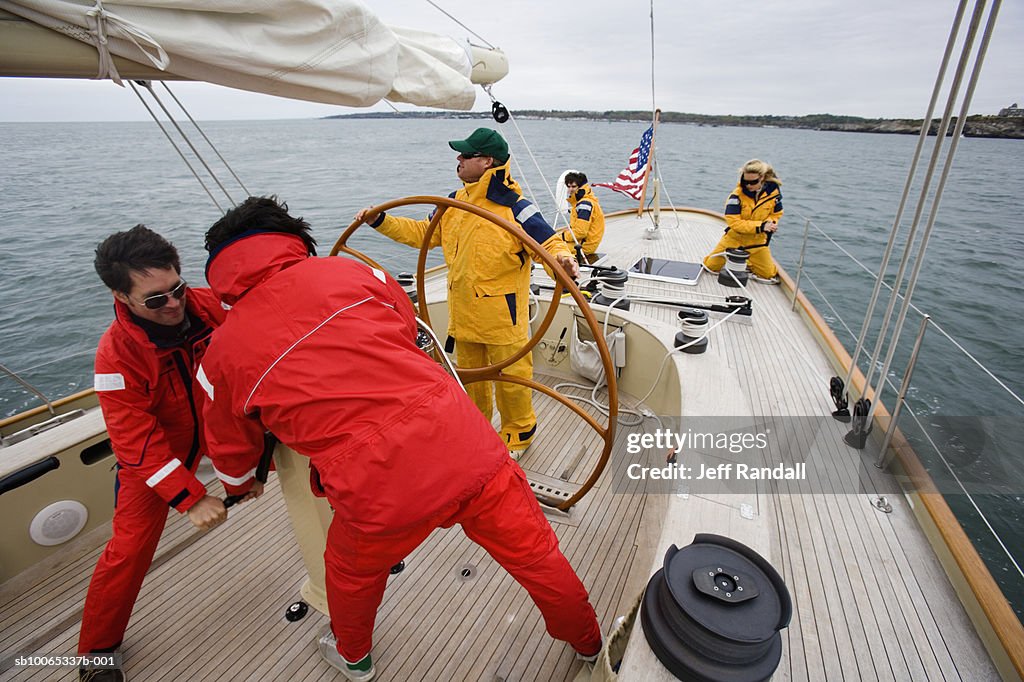 Crew sailing racing yacht