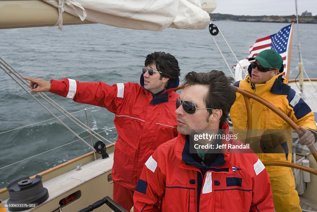 Crew sailing racing yacht