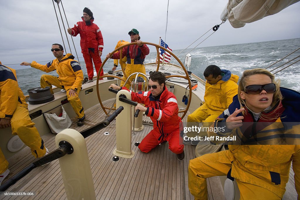 Crew sailing racing yacht