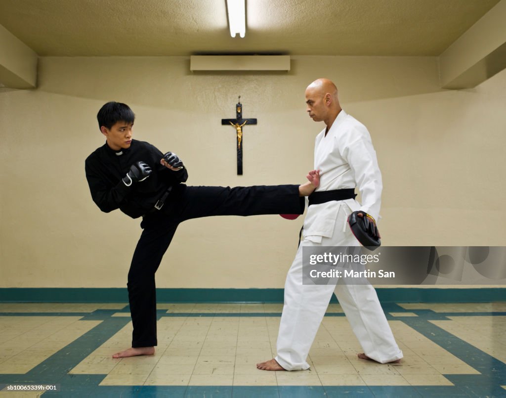Instructor teaching martial arts to young priest