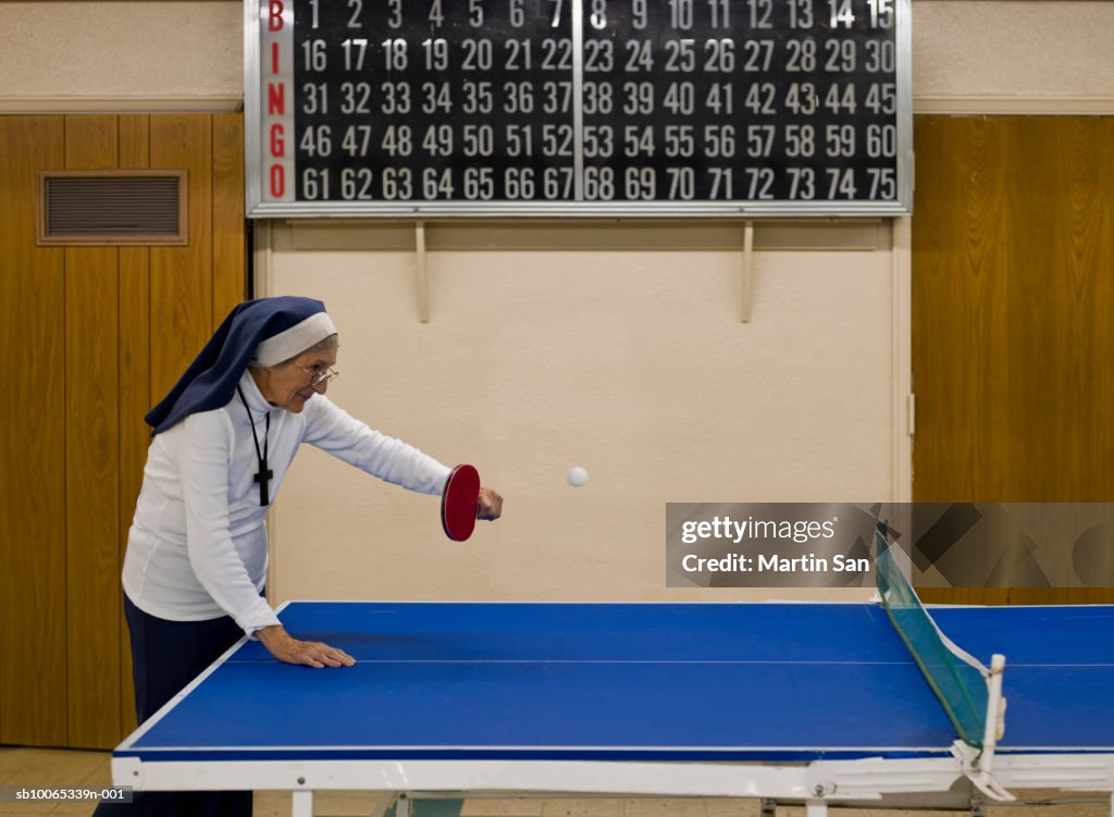 Senior nun playing table tennis