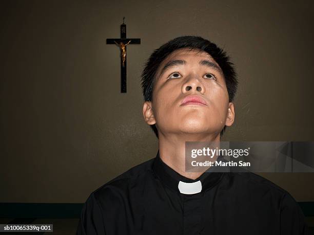 young priest looking up - priest collar stock pictures, royalty-free photos & images