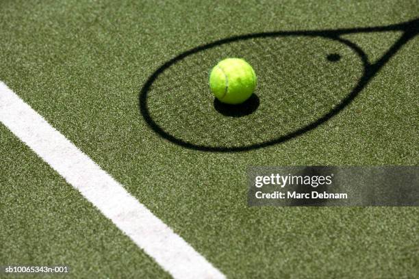 tennis ball with racket shadow on court - tennis racquet stock pictures, royalty-free photos & images