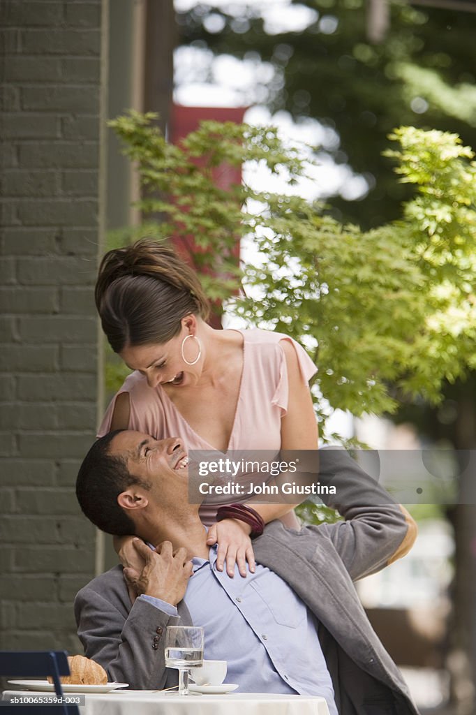 Couple embracing at outdoor cafe