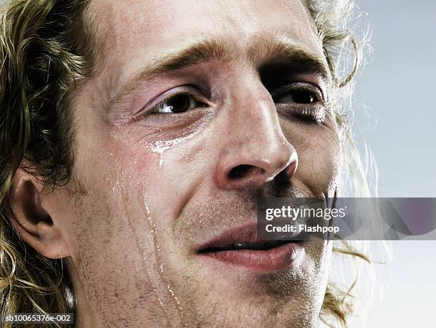 young man crying, close-up - emoción fotografías e imágenes de stock