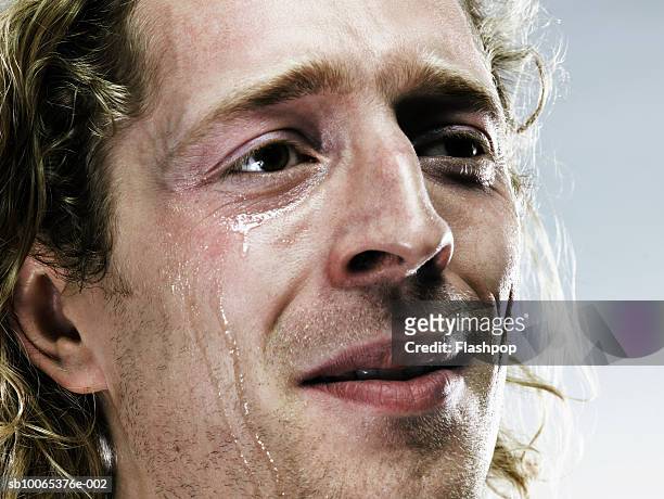 young man crying, close-up - delusione foto e immagini stock