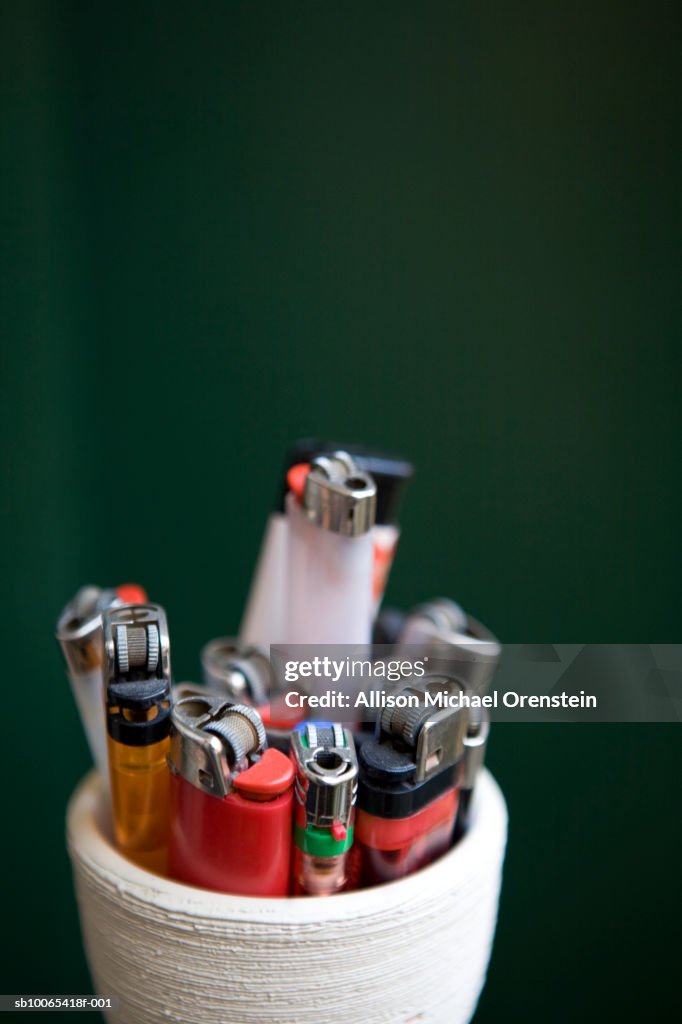 Cigarette lighters in cup, close-up