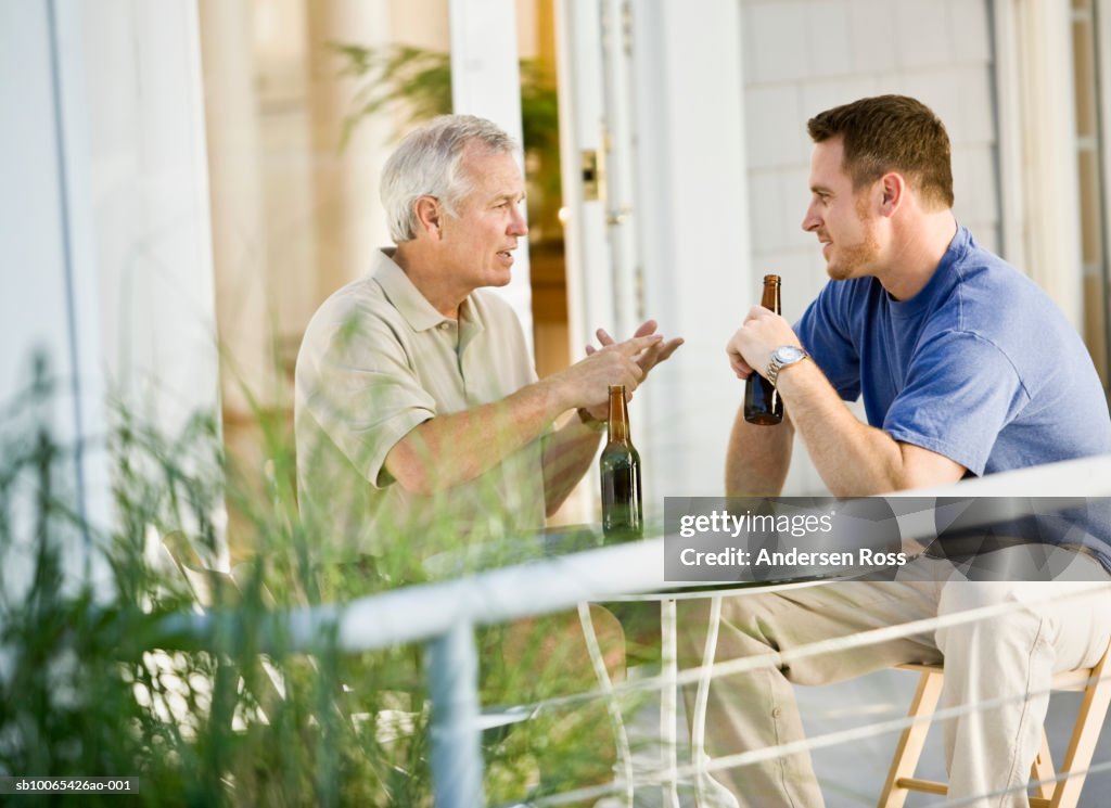 Senior Man and Man drinking Beers and talking