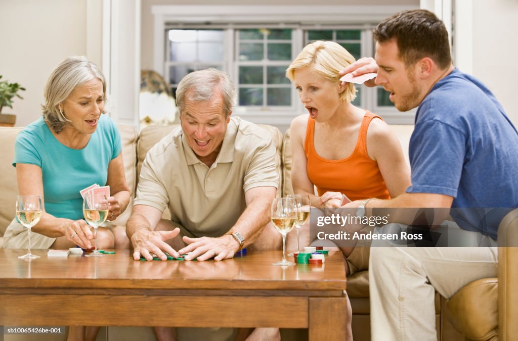 Family playing Poker and drinking wine