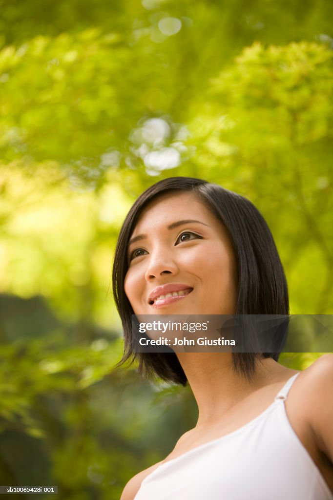 Close-up of young woman smiling outdoors