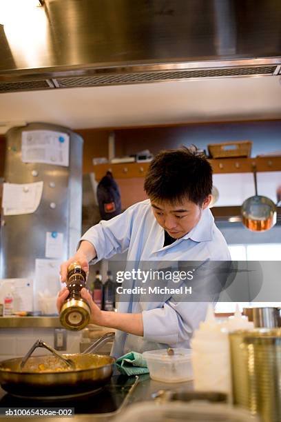 chef adding pepper into steaming pan - adding pepper stock pictures, royalty-free photos & images