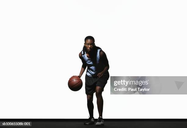 young woman holding basketball - dribbling basketball stock pictures, royalty-free photos & images