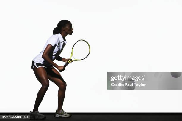 young woman playing tennis, side view - tennis racquet isolated stock pictures, royalty-free photos & images