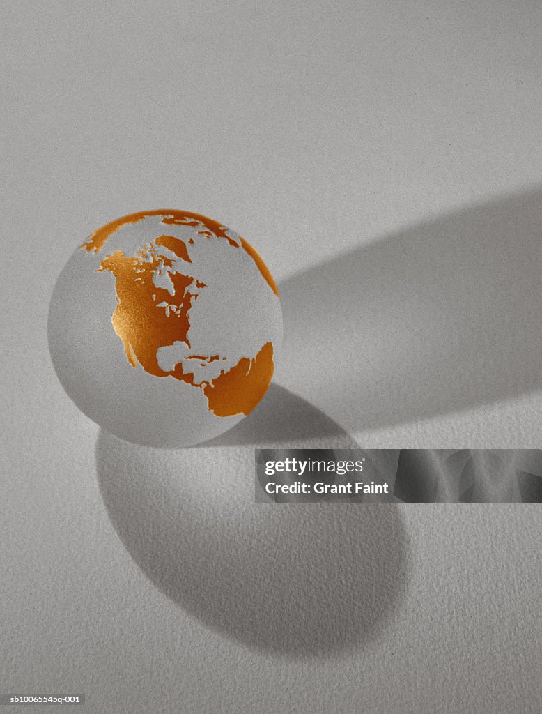 Transparent globe with golden continents