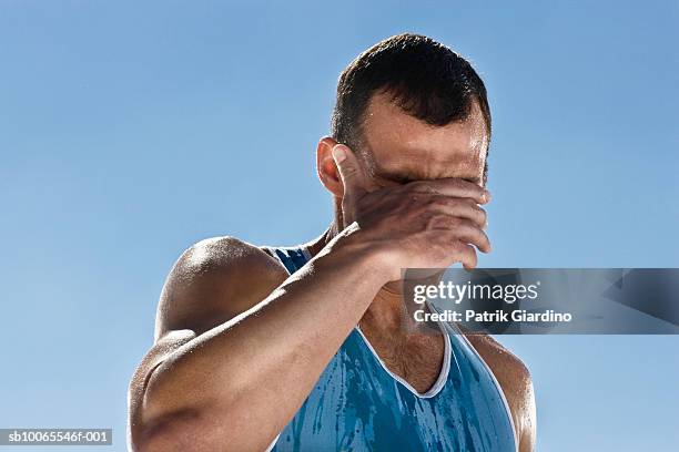 man cleaning sweat from face, close-up - man sweating bildbanksfoton och bilder