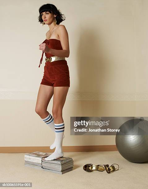 young woman exercising on books - gym fashion stock pictures, royalty-free photos & images