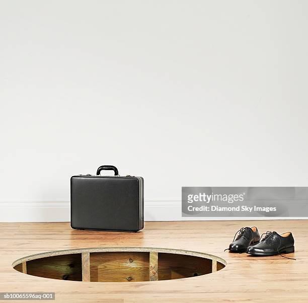 hole in wooden floor with suitcase and shoe besides - trou sol photos et images de collection