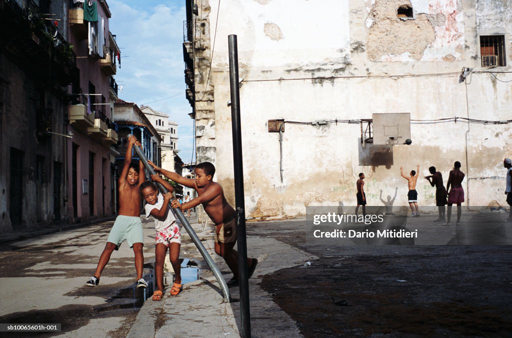 Cuba, Havana, Plaza de la Revolution, boys (8-10) playing on street