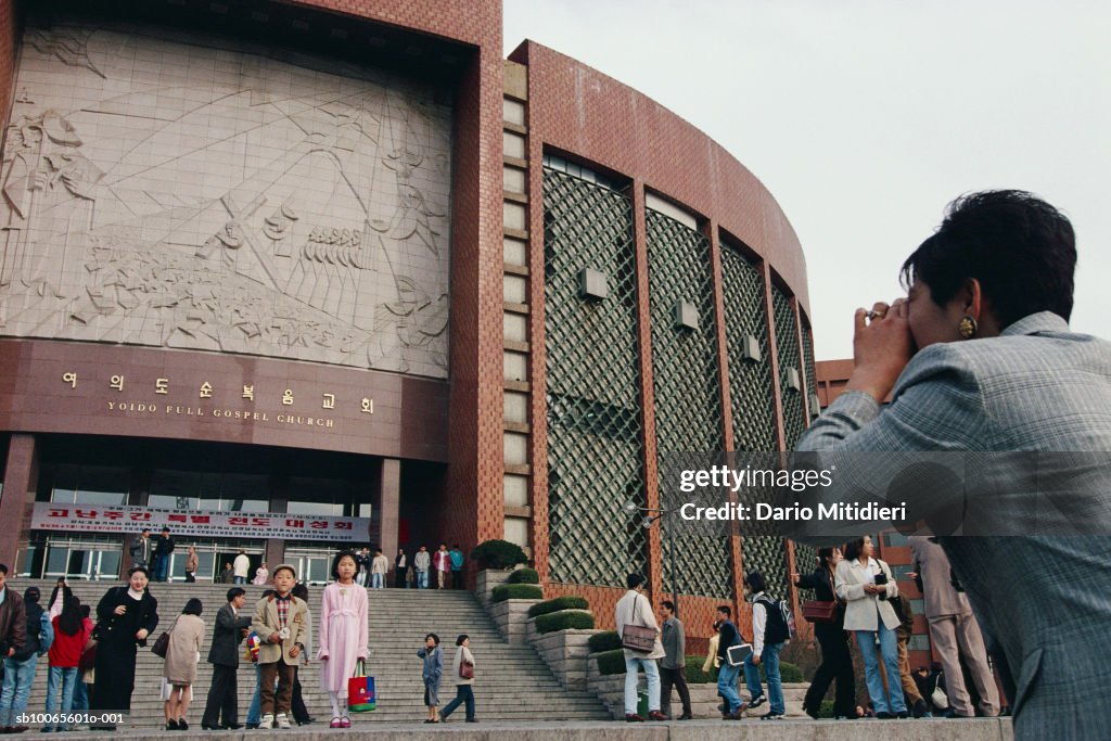 South Korea, Seoul, woman photographing  Yoido Full Gospel Church