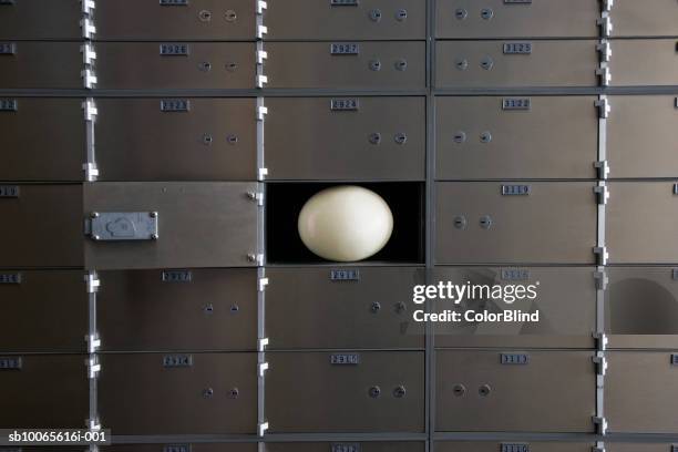 open safety deposit box with ostrich egg inside - safe deposit box stock pictures, royalty-free photos & images