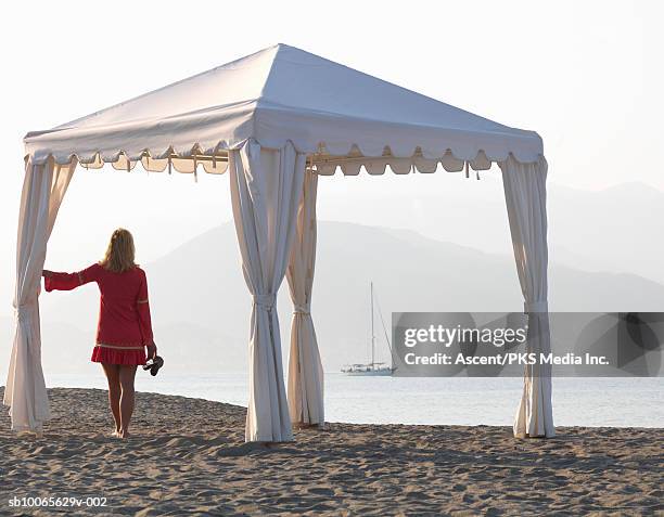 mature woman on beach looking at view - luxury tent stock pictures, royalty-free photos & images