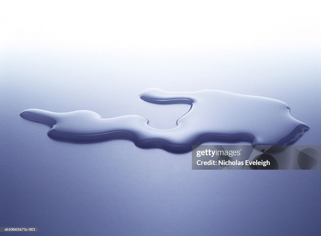 Puddle of water on white surface, studio shot