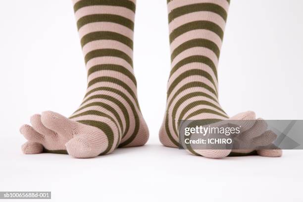 close-up of legs in striped socks, low section - teen stockfoto's en -beelden