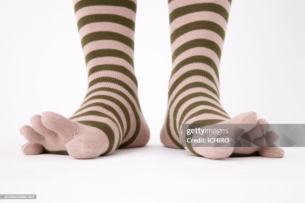 Close-up of legs in striped socks, low section