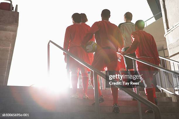 male soccer team entering stadium - football ストックフォトと画像