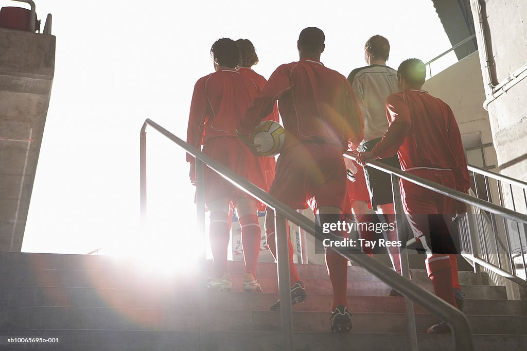 Male soccer team entering stadium