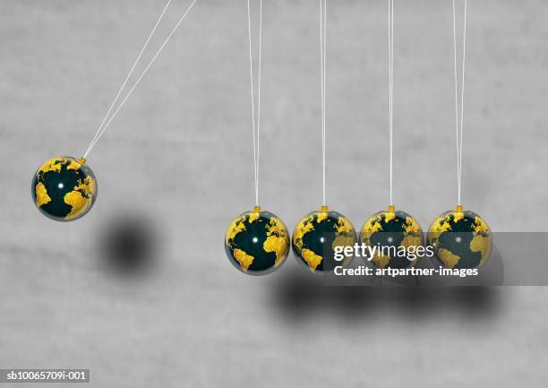 globes hanging - newtons cradle stockfoto's en -beelden