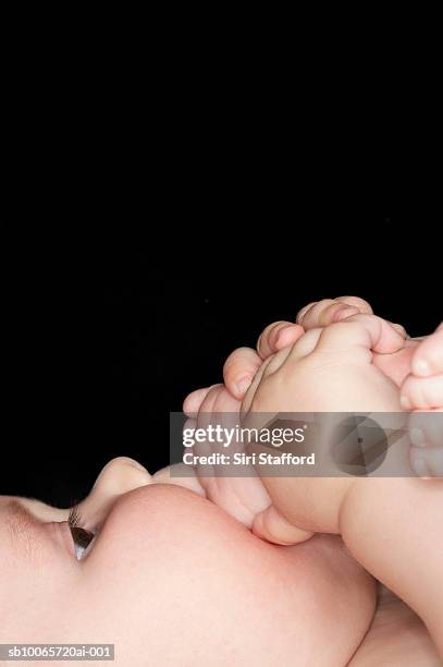 baby boy (6-9 months) sucking toes, close-up - feet sucking stock pictures, royalty-free photos & images