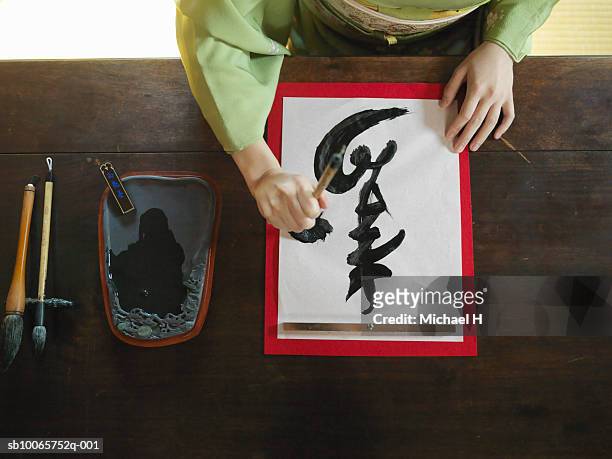 woman writing calligraphy - japanese brush stroke stock pictures, royalty-free photos & images