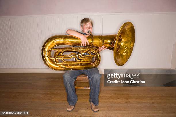 boy (8-9) playing tuba - tube foto e immagini stock