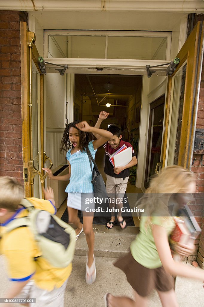 Children (8-15) leaving schools, cheering, blurred motion