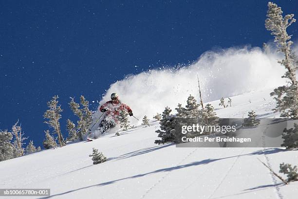 young man skiing in powder snow - snowbird lodge stock pictures, royalty-free photos & images